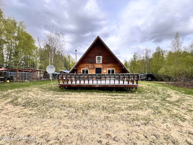 rear view of property featuring a yard and a deck