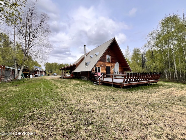 rear view of property with a yard and a deck