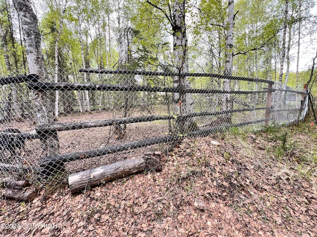 view of gate with an outbuilding