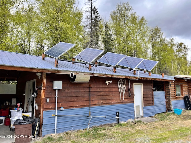 view of side of property featuring solar panels