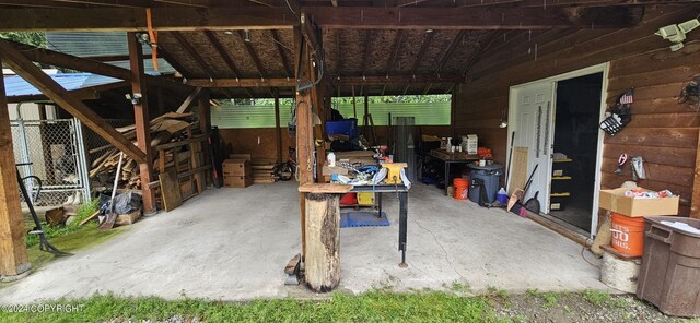 exterior space with wooden walls and concrete flooring