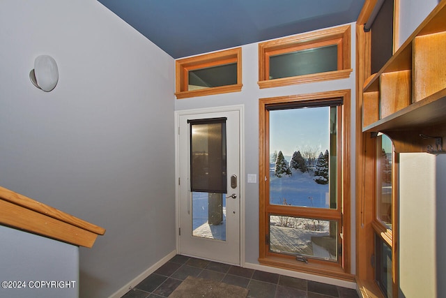 entrance foyer with dark tile patterned floors