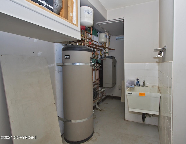 utilities featuring sink and strapped water heater