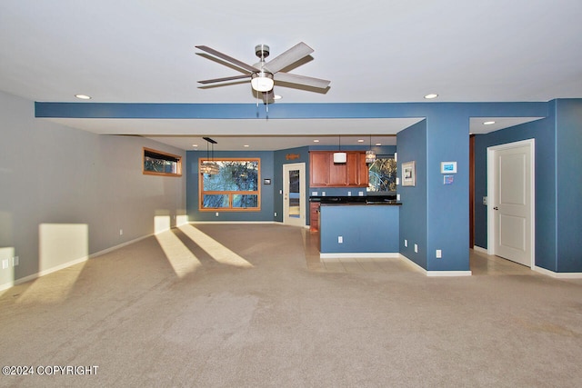 unfurnished living room with ceiling fan and light carpet