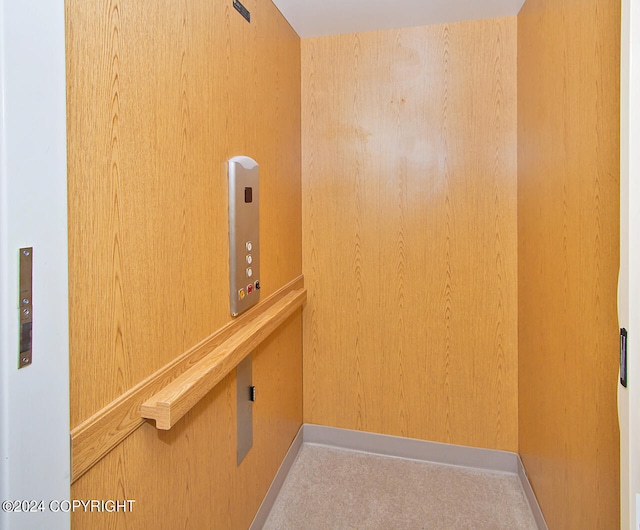 interior space featuring carpet flooring and elevator