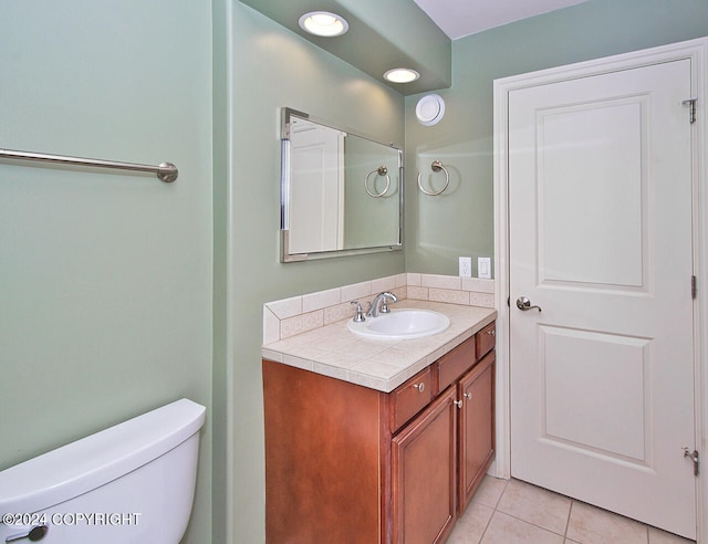 bathroom with tile patterned flooring, toilet, and vanity