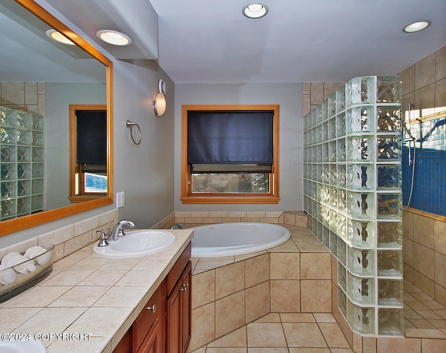 bathroom featuring tile patterned flooring, independent shower and bath, and vanity