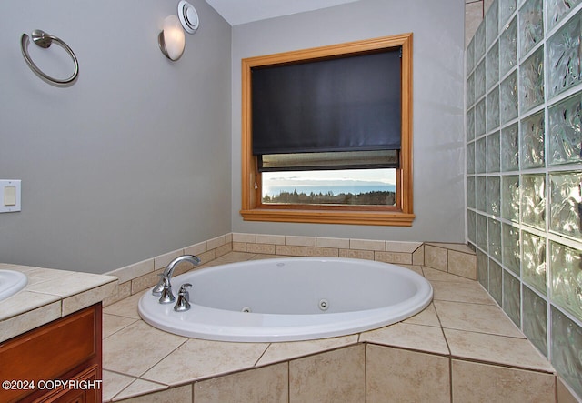 bathroom featuring tiled tub and vanity