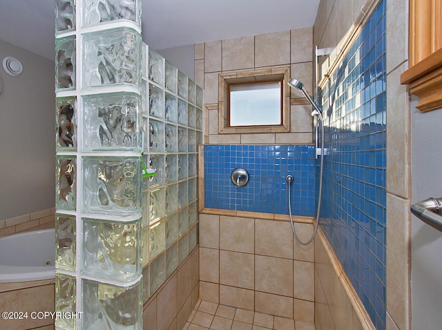 bathroom featuring plus walk in shower and tile walls