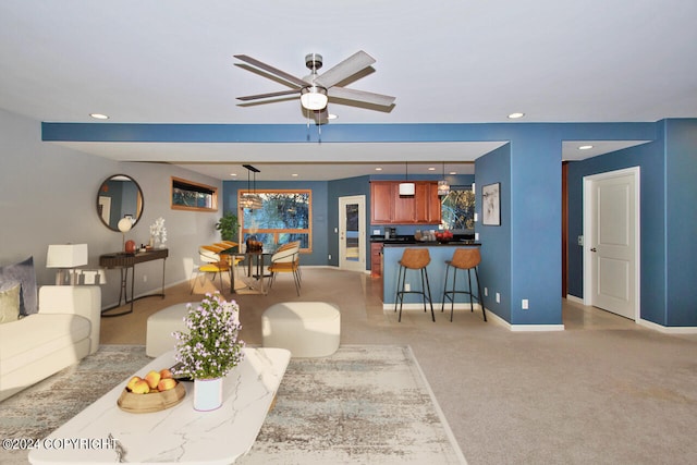 carpeted living room featuring ceiling fan