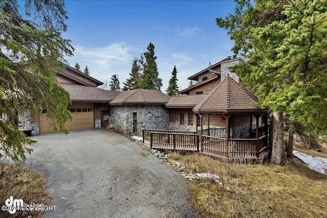 view of front of property featuring a garage and a deck