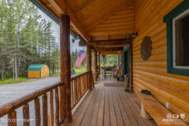 wooden deck featuring a shed