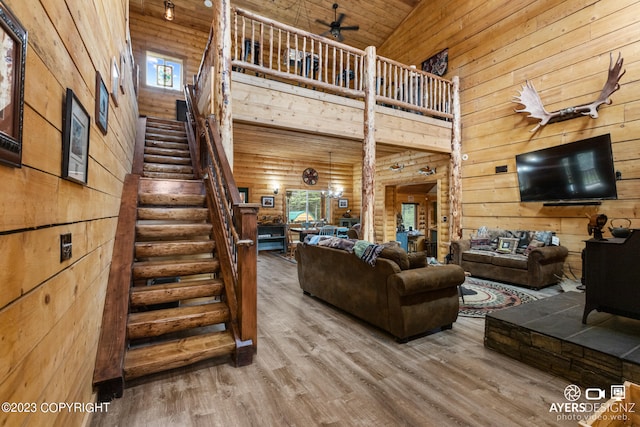 living room featuring high vaulted ceiling, light hardwood / wood-style floors, wooden ceiling, and ceiling fan