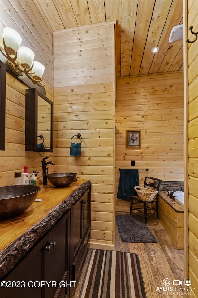 bathroom with wooden walls, hardwood / wood-style floors, wood ceiling, and dual bowl vanity