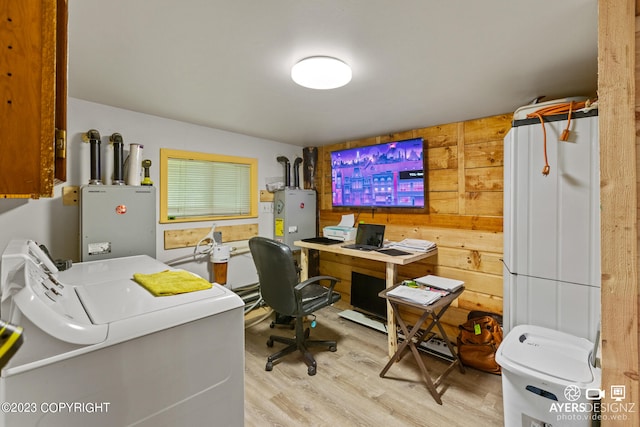 office with wooden walls, light hardwood / wood-style floors, independent washer and dryer, and water heater