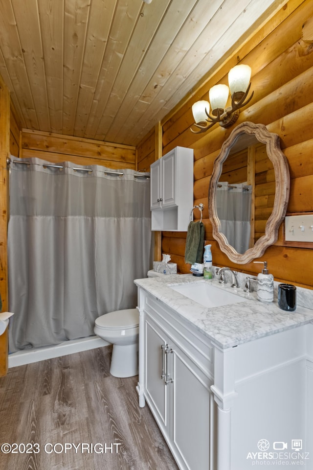 bathroom with hardwood / wood-style floors, log walls, toilet, wooden ceiling, and oversized vanity