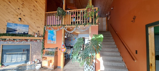 9450 Keshon Cir, Wasilla, AK 99654 - stairs featuring a glass covered fireplace, wooden walls, and wood finished floors
