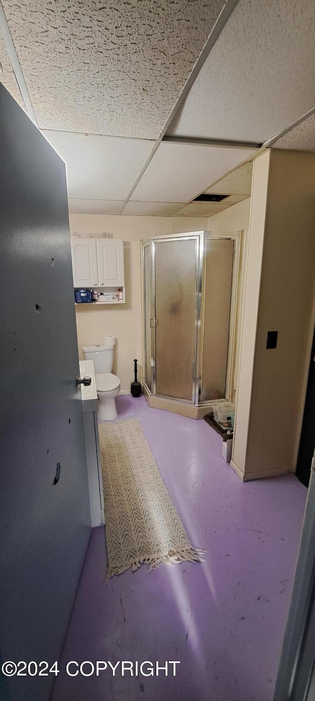 9450 Keshon Cir, Wasilla, AK 99654 - full bath featuring a stall shower, toilet, concrete flooring, and a paneled ceiling