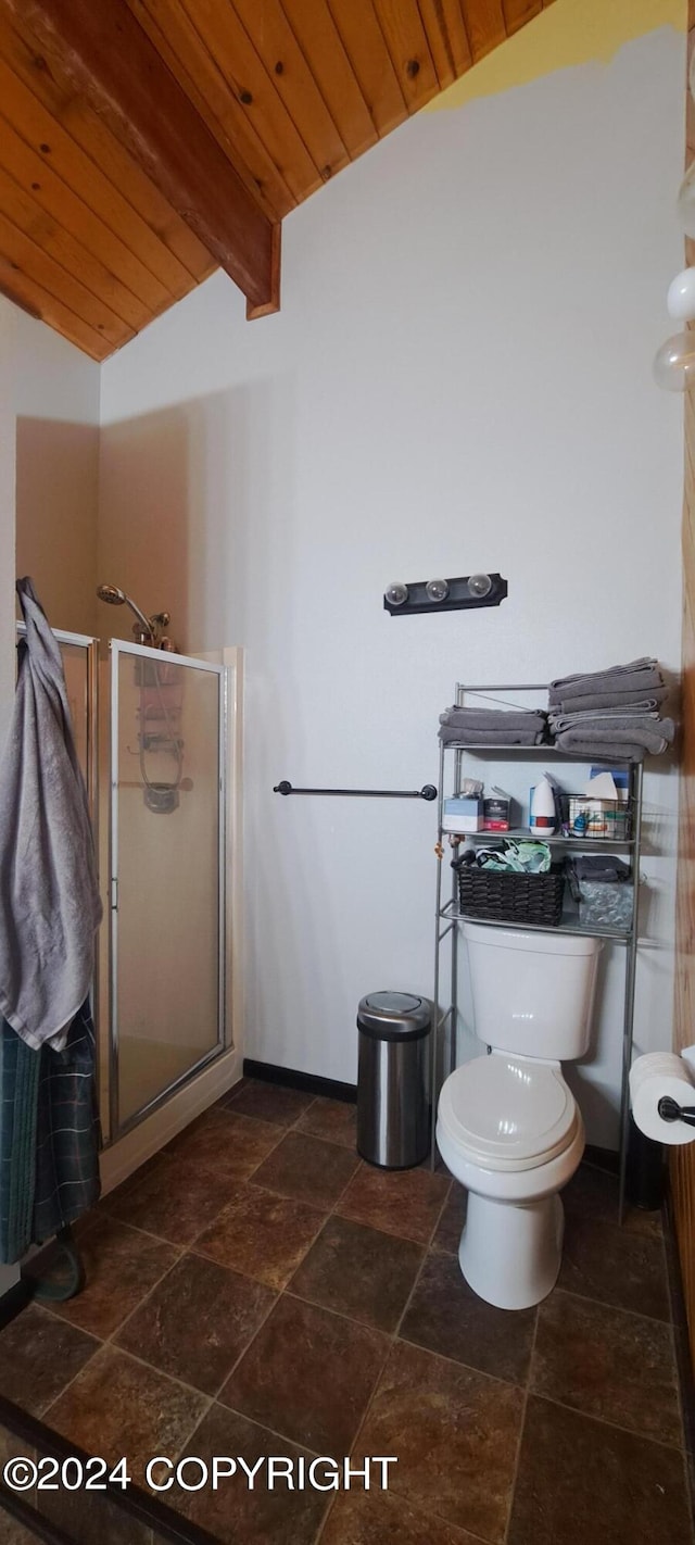 9450 Keshon Cir, Wasilla, AK 99654 - full bathroom featuring stone tile floors, a stall shower, wood ceiling, and toilet