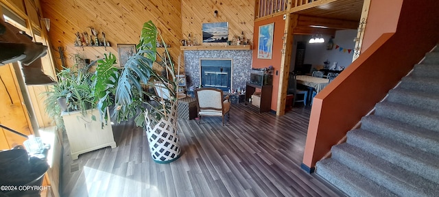 9450 Keshon Cir, Wasilla, AK 99654 - living room featuring wood finished floors, wooden walls, stairs, and a fireplace
