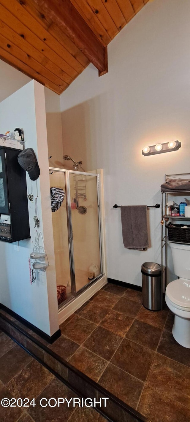 9450 Keshon Cir, Wasilla, AK 99654 - full bath featuring stone tile floors, wooden ceiling, toilet, a shower stall, and baseboards