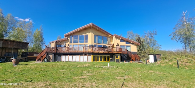 back of property featuring a wooden deck and a yard