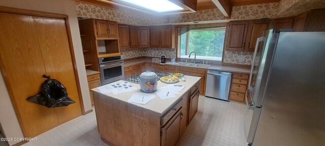 9450 Keshon Cir, Wasilla, AK 99654 - kitchen with stainless steel appliances, a sink, a kitchen island, and light countertops