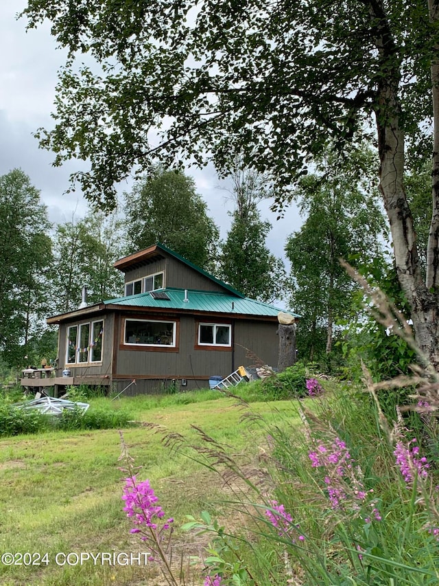 view of side of property with a yard