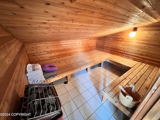 view of sauna / steam room featuring wooden walls, tile patterned floors, and wood ceiling