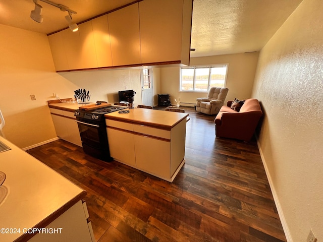 kitchen featuring rail lighting, black electric range oven, a textured ceiling, kitchen peninsula, and dark wood-type flooring