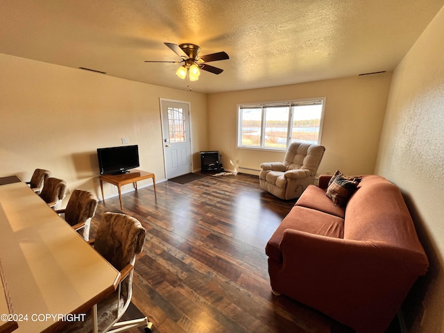 living room with a baseboard radiator, a textured ceiling, ceiling fan, and wood-type flooring