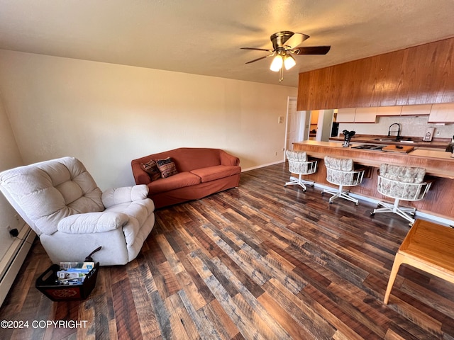 home office featuring sink, a baseboard heating unit, hardwood / wood-style flooring, and ceiling fan