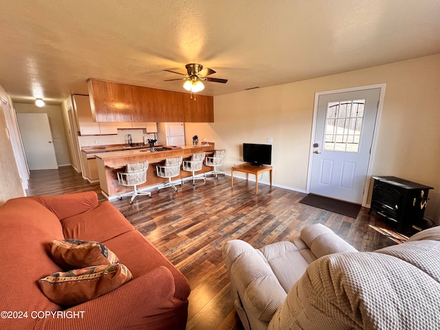 living room with dark hardwood / wood-style floors and ceiling fan