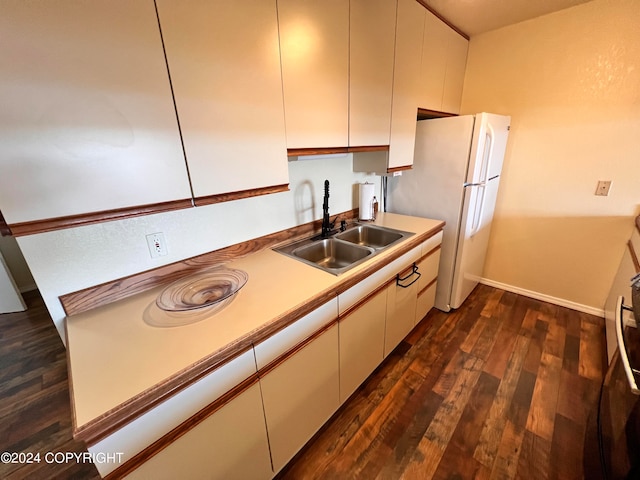 kitchen with sink, white refrigerator, and dark hardwood / wood-style floors