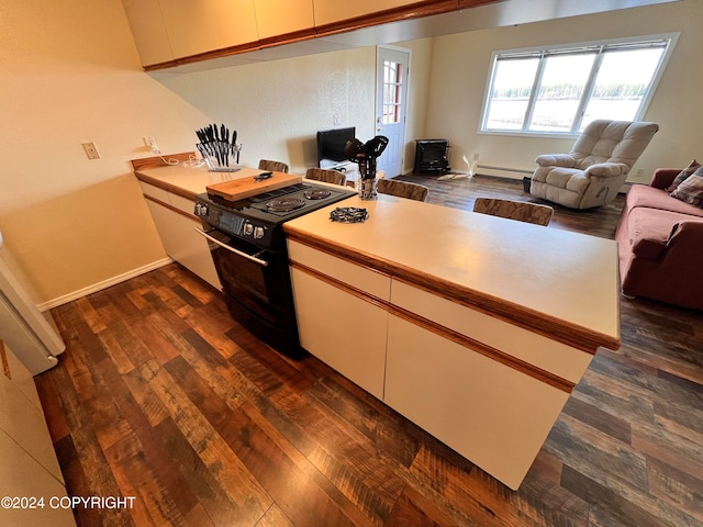 kitchen with dark hardwood / wood-style floors, baseboard heating, kitchen peninsula, and black electric range