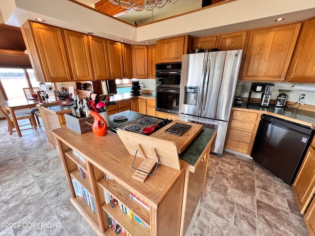 kitchen featuring black appliances, a notable chandelier, and light tile patterned floors