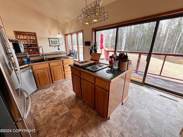 kitchen with sink, lofted ceiling, tile patterned flooring, and stainless steel appliances