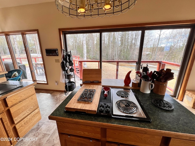 kitchen featuring an inviting chandelier, light tile patterned flooring, and a healthy amount of sunlight