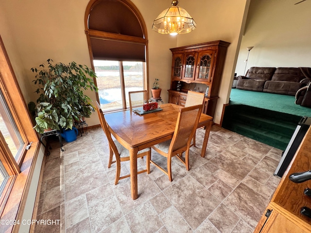 tiled dining area with an inviting chandelier