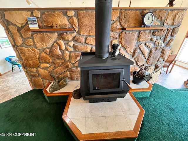 details with tile patterned floors and a wood stove