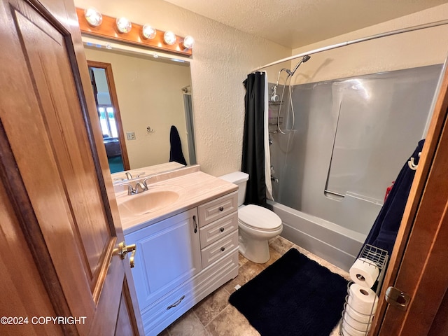 full bathroom with a textured ceiling, toilet, vanity, tile patterned floors, and shower / tub combo