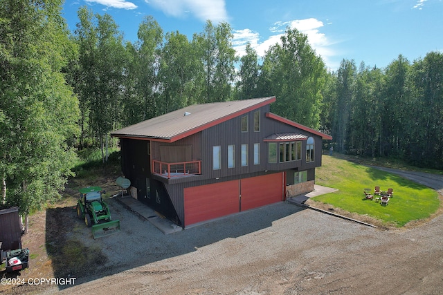 view of side of property with a garage and a yard