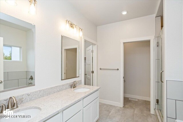 bathroom featuring tile patterned flooring and vanity