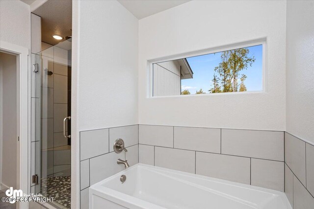 bathroom featuring plus walk in shower