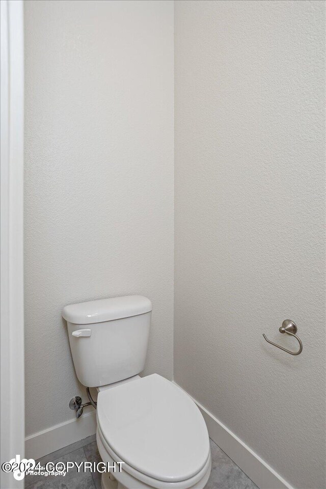 bathroom featuring tile patterned flooring and toilet