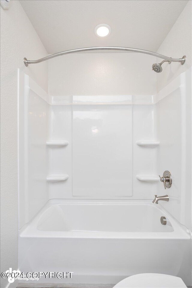 bathroom with toilet and shower / washtub combination