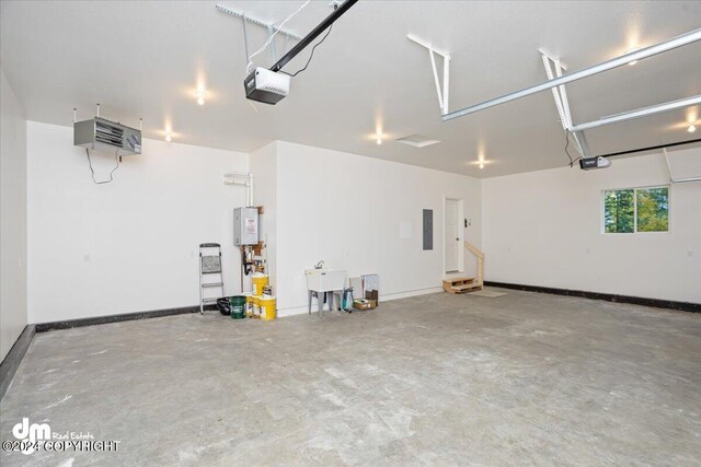 garage with electric panel, a garage door opener, and sink