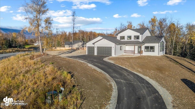 view of front of home featuring covered porch and a garage