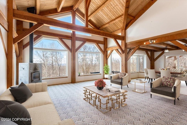 carpeted living room featuring beamed ceiling, a healthy amount of sunlight, and a fireplace