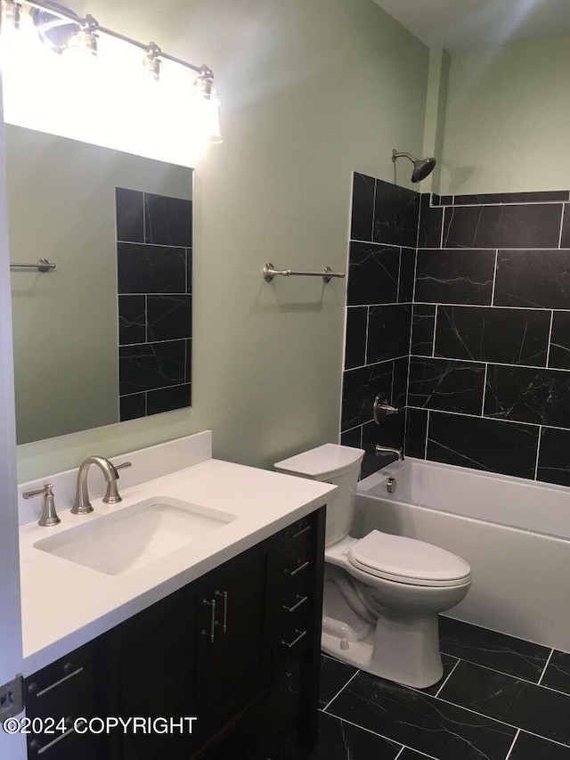 full bathroom with vanity, toilet, and tiled shower / bath